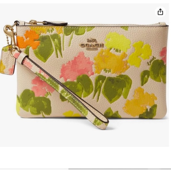 COACH Dreamy florals adorn polished pebble leather with this charming wristlet